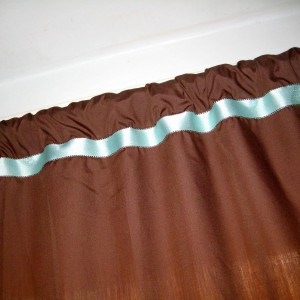 adding a pale blue ribbon to brown curtains