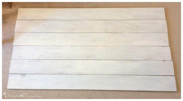 painted pine boards being laid out to make a headboard