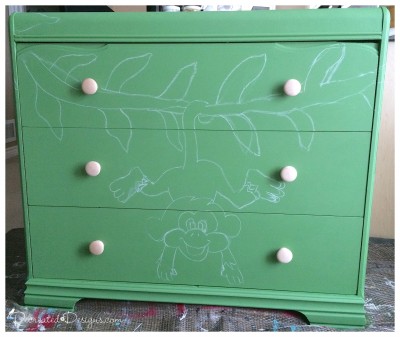 chalking out a design to paint on a dresser