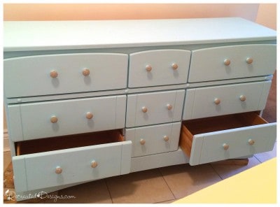 old dresser being recreated with paint and new knobs