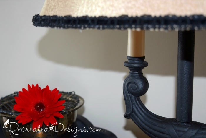 black mat paint with glaze over top and a red flower