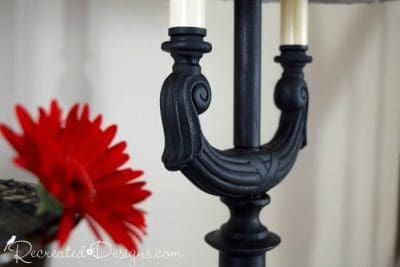 a close up of some Country Chic Paint in Licorice and a red flower