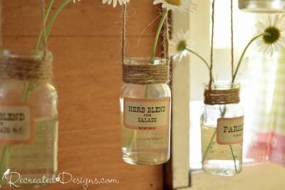 hanging spice bottles with wildflowers