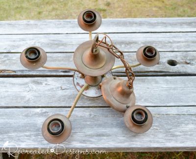 the top of an old, rusty chandelier found at a dump