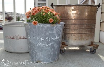 a collection of metal pails that will be used for flowers