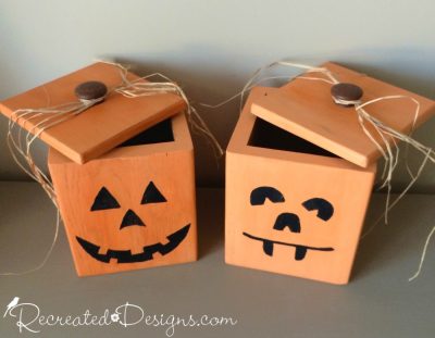 wood canisters turned into jack-o-lanterns to hold candy