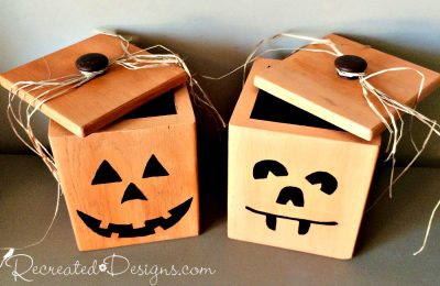 Two vintage wood canisters painted like Jack-O-Lanterns to hold Halloween treats