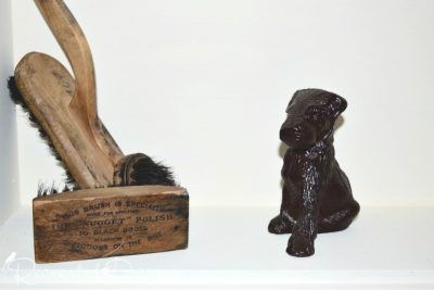 antique shoe shine brushes and cast iron dog