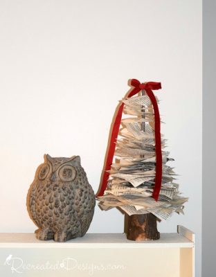a paper tree next to an owl