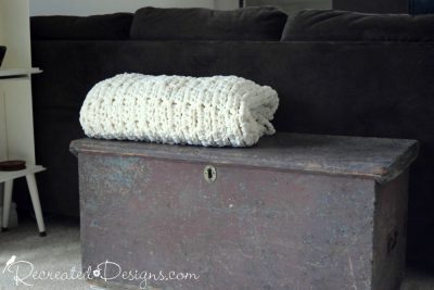 antique wood box with a large, cozy blanket