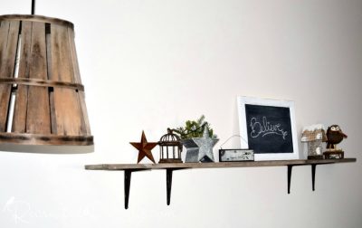 reclaimed wood shelf with holiday decor and wood basket hanging lamp