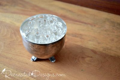 glass flower frog in a silver cup