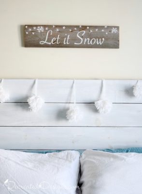 Snowballs hanging on a handmade Farmhouse headboard