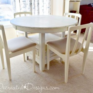 a dark coloured dining set painted with cream coloured paint