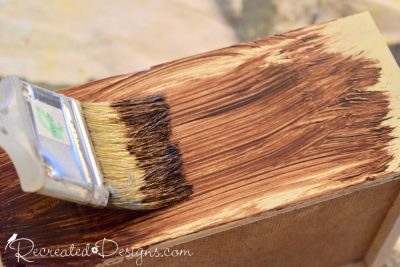 Applying General Finishes Gel Stain in Nutmeg with a chip brush to painted pine