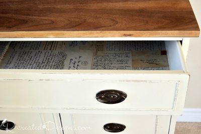 vintage buffet drawer filled with decoupaged old letters and cards