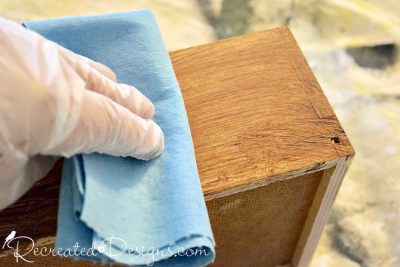 rubbing off excess stain with a shop towel