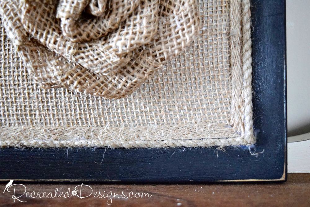 burlap over a reclaimed cork board with a painted black frame