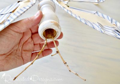 attaching twigs inside of an old spindle