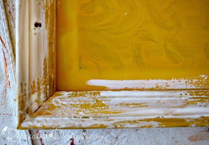 applying layer of glue over yellow paint to get crackle effect