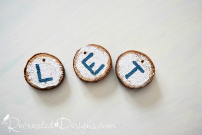 Wood slices painted with Metallic Pearl paint with blue letters