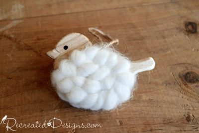 little wood bird covered in natural wool