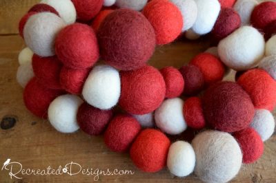red and white balls of wool made into a garland
