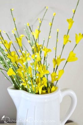 Yellow flowers in a white jug for Spring