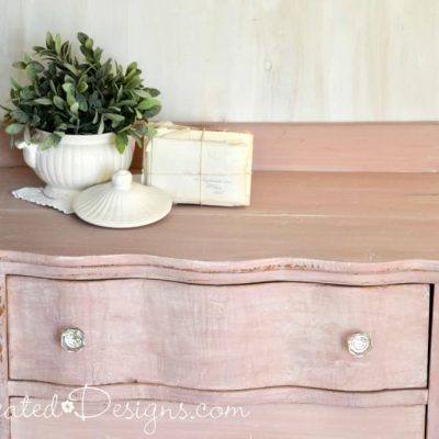 vintage Ironstone on top of a pink painted dresser