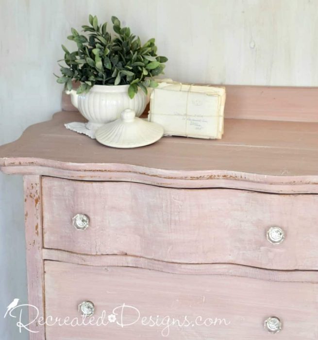 vintage ironstone and an old stack of letter on a pink milk painted dresser