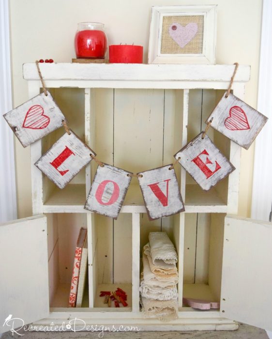 wooden love garland hanging on cabinet