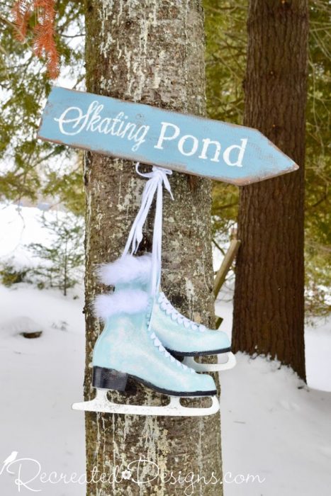 painted skates hanging with a Skating Pond sign