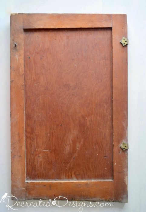 an old door before being upcycled