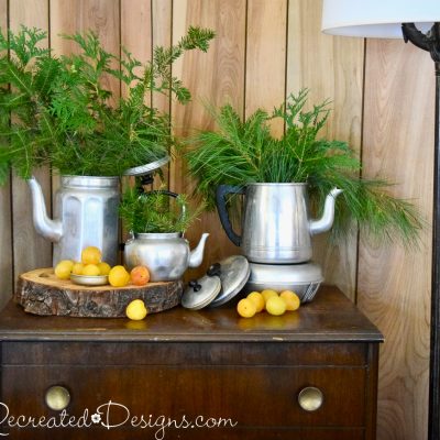 vintage coffee pots with evergreens
