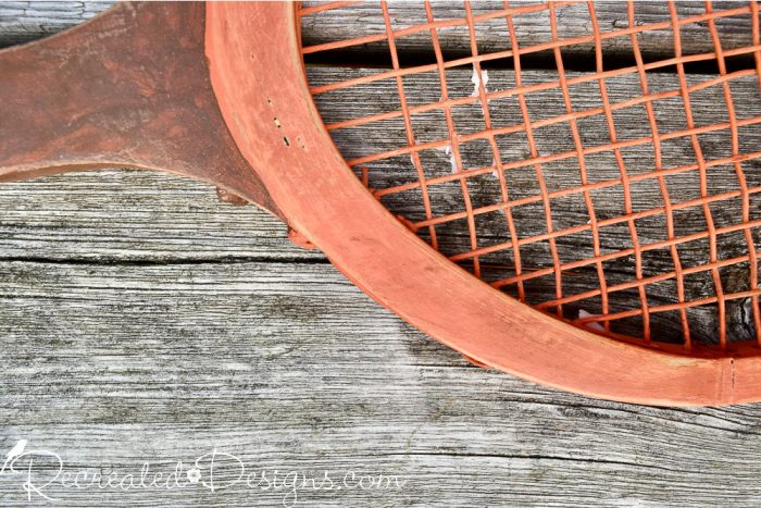 dark wax over orange paint on a tennis racket