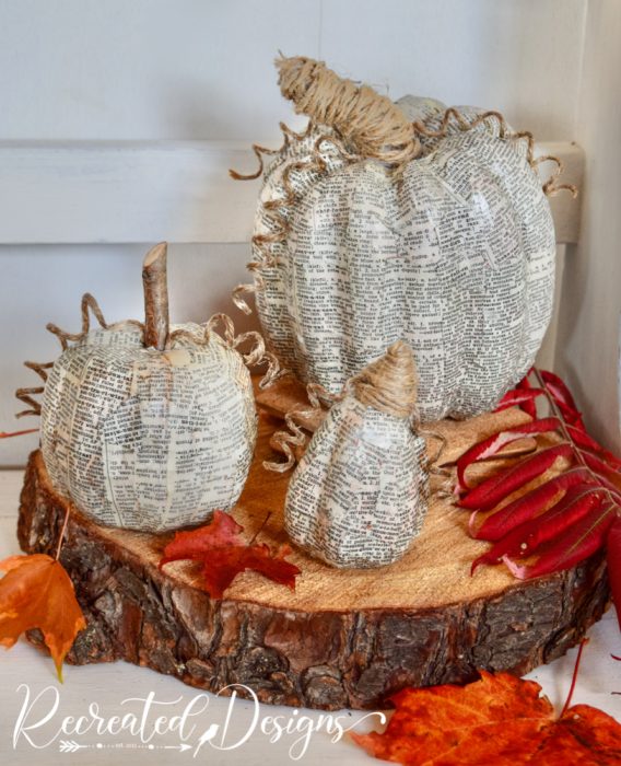 decoupaged book pages on pumpkins