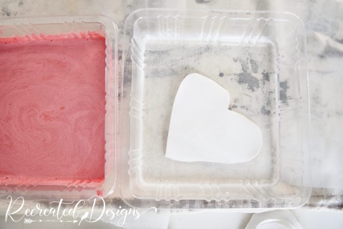 dipping a fabric heart into water