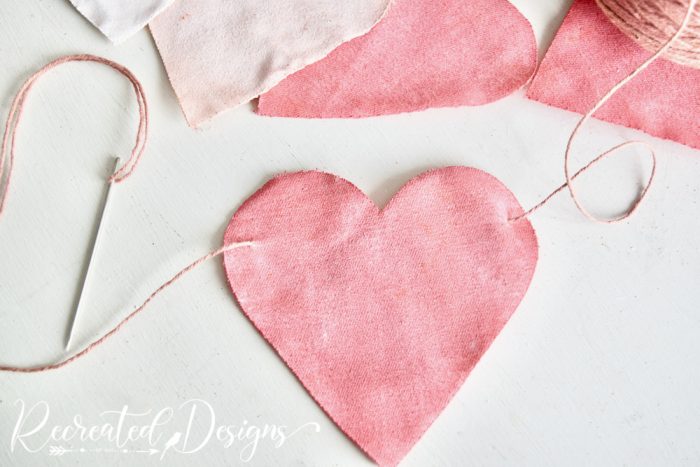 adding vintage string to fabric hearts