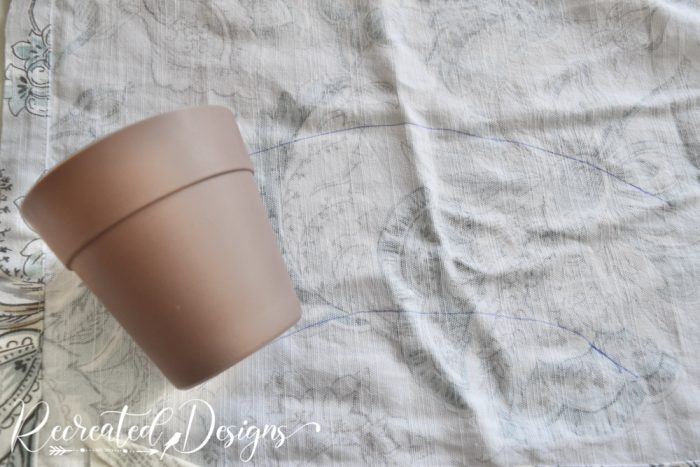 tracing a plastic flower pot on fabric