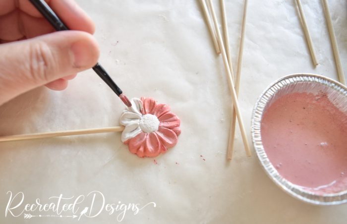 painting clay flowers with pink milk paint