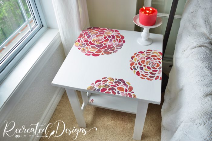 table painted white with textured flowers in multicolors