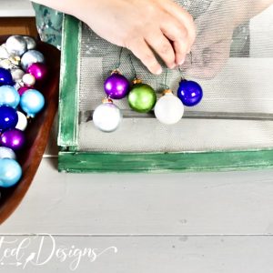 adding colourful ornaments to an old screen window