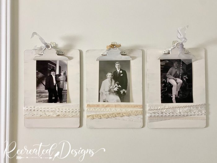 clipboards reused as photo hangers on a wall