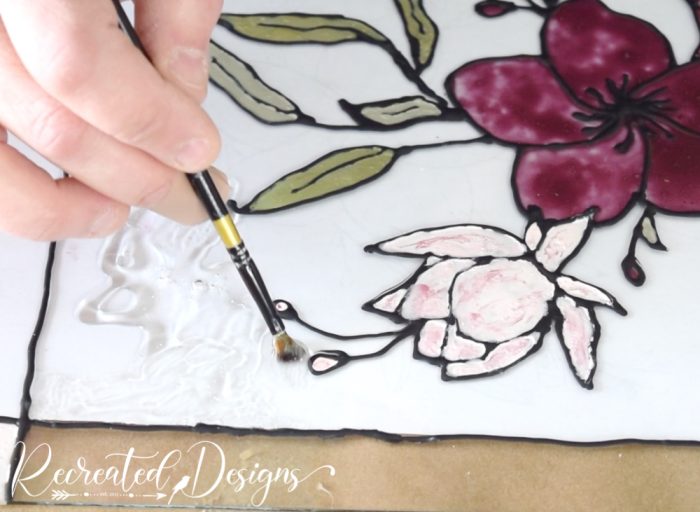 adding clear glue to create faux stained glass