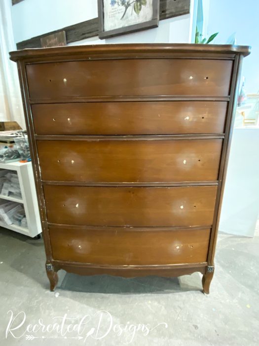 vintage dresser with holes being filled in