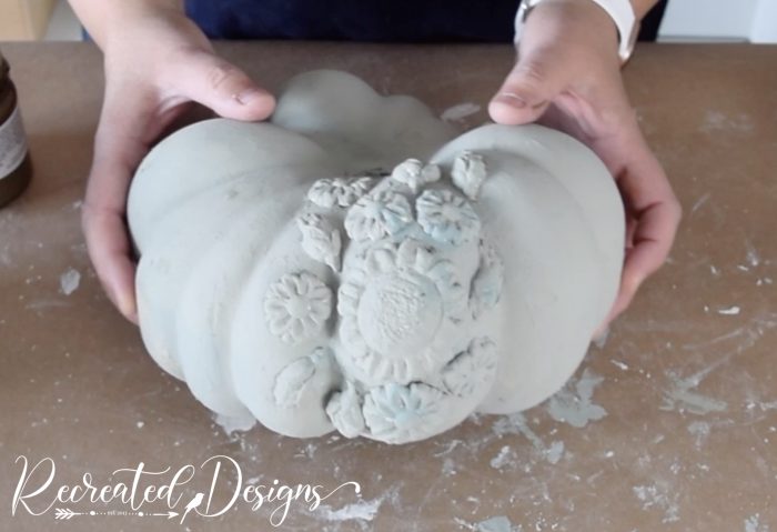 painting air dry clay flowers on a pupmkin with Annie Sloan paint