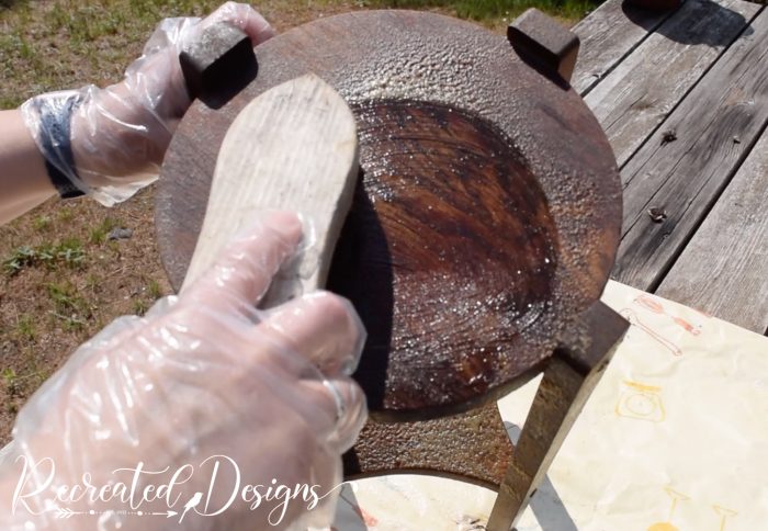 scrubbing a vintage plant stand with Easy Off oven cleaner