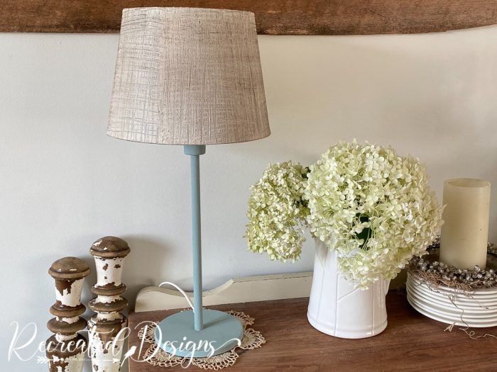 a lamp sittting on a buffet